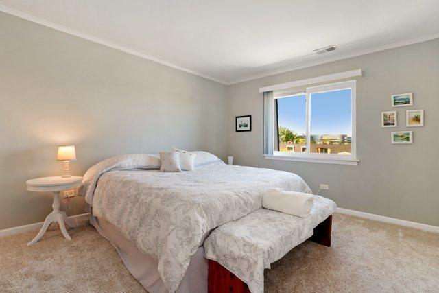 3256 Sanders Rd Unit 4E, Northbrook, IL 60062 - carpeted bedroom featuring baseboards and ornamental molding