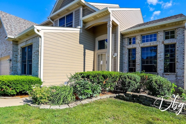 582 Aspen Way, Antioch, IL 60002 - entrance to property with an attached garage and a lawn
