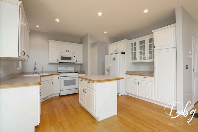 582 Aspen Way, Antioch, IL 60002 - kitchen featuring white appliances, white cabinetry, light wood-type flooring, light countertops, and recessed lighting