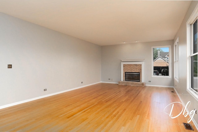582 Aspen Way, Antioch, IL 60002 - unfurnished living room featuring light wood finished floors and a fireplace