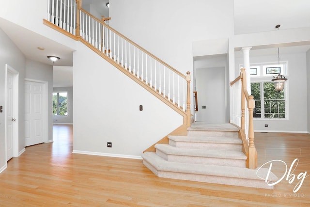 582 Aspen Way, Antioch, IL 60002 - staircase featuring wood finished floors, a high ceiling, and decorative columns