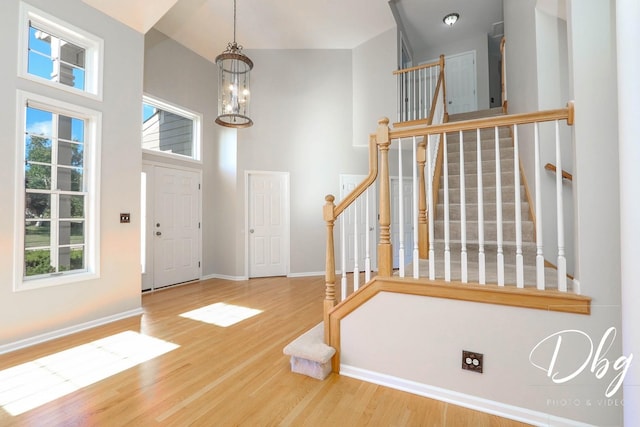 582 Aspen Way, Antioch, IL 60002 - foyer entrance with stairs, wood finished floors, a towering ceiling, and a chandelier