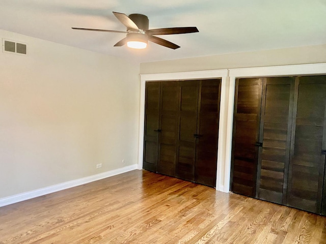 824 62nd St, Downers Grove, IL 60516 - unfurnished bedroom with two closets, light wood-type flooring, and ceiling fan