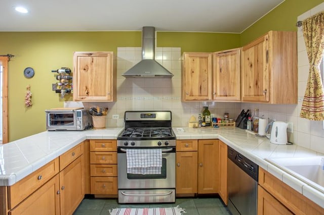7842 S Blazer Ave, Justice, IL 60458 - kitchen with wall chimney exhaust hood, appliances with stainless steel finishes, tile countertops, a peninsula, and recessed lighting