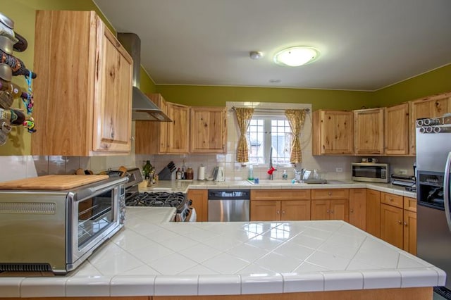 7842 S Blazer Ave, Justice, IL 60458 - kitchen featuring stainless steel appliances, wall chimney exhaust hood, decorative backsplash, a peninsula, and tile countertops