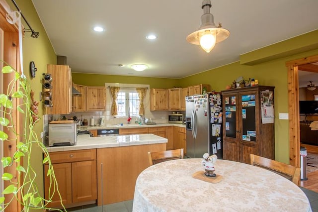 7842 S Blazer Ave, Justice, IL 60458 - kitchen featuring appliances with stainless steel finishes, tile countertops, a peninsula, recessed lighting, and pendant lighting
