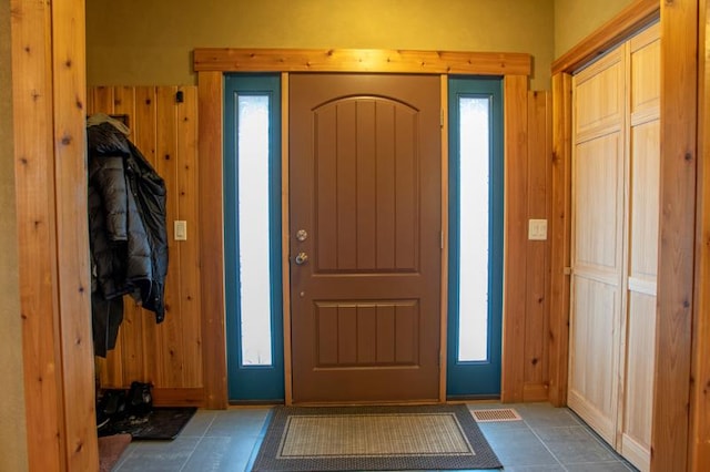 7842 S Blazer Ave, Justice, IL 60458 - tiled entryway featuring wood walls and plenty of natural light