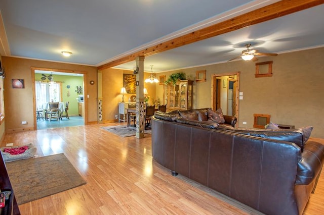 7842 S Blazer Ave, Justice, IL 60458 - living area featuring light wood finished floors, crown molding, a chandelier, ornate columns, and a ceiling fan