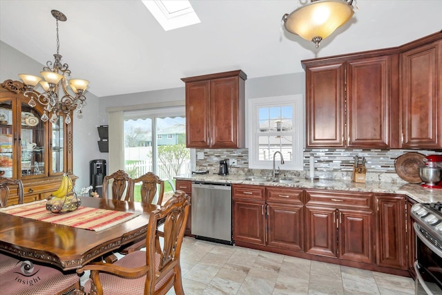 16529 Edgewood Dr, Plainfield, IL 60544 - kitchen with appliances with stainless steel finishes, backsplash, a skylight, light stone counters, and hanging light fixtures