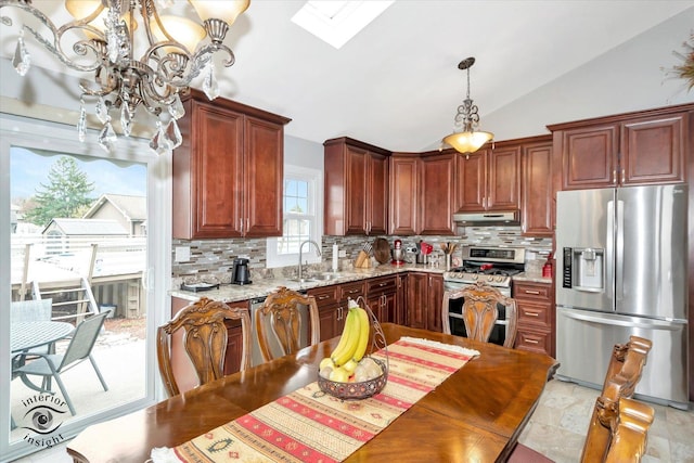 16529 Edgewood Dr, Plainfield, IL 60544 - kitchen with stainless steel appliances, a chandelier, under cabinet range hood, backsplash, and a skylight