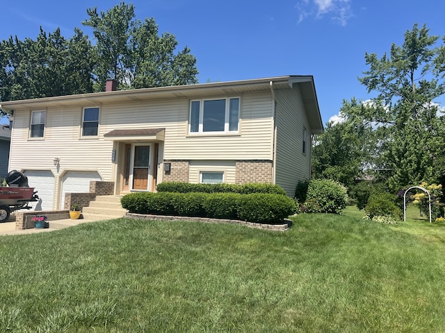 980 Hillcrest Blvd, Hoffman Estates, IL 60169 - raised ranch featuring brick siding, a front lawn, an attached garage, and a chimney