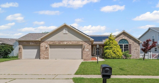 402 Wesley Ave, Savoy, IL 61874 - single story home featuring brick siding, an attached garage, solar panels, and concrete driveway