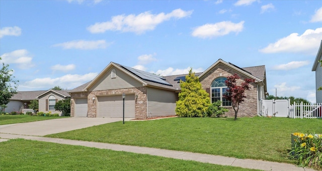 402 Wesley Ave, Savoy, IL 61874 - ranch-style home with brick siding, solar panels, a garage, concrete driveway, and a gate