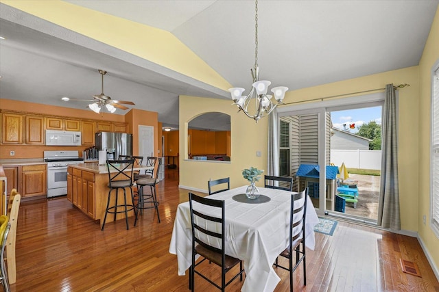 402 Wesley Ave, Savoy, IL 61874 - dining room featuring lofted ceiling, a chandelier, healthy amount of natural light, wood-type flooring, and ceiling fan