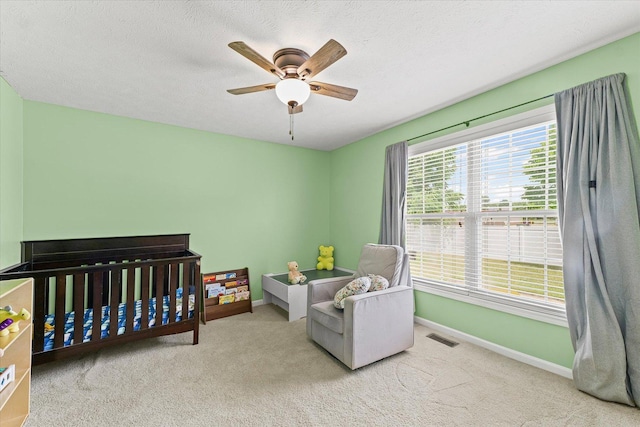402 Wesley Ave, Savoy, IL 61874 - carpeted bedroom with a nursery area and ceiling fan
