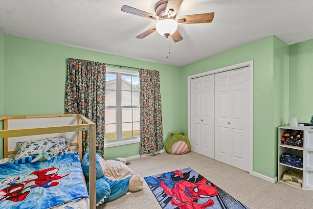 402 Wesley Ave, Savoy, IL 61874 - carpeted bedroom with a textured ceiling, ceiling fan, and a closet
