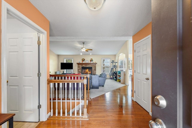 402 Wesley Ave, Savoy, IL 61874 - foyer featuring ceiling fan, a fireplace, and wood finished floors