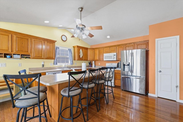 402 Wesley Ave, Savoy, IL 61874 - kitchen with white appliances, lofted ceiling, light countertops, wood finished floors, and a ceiling fan
