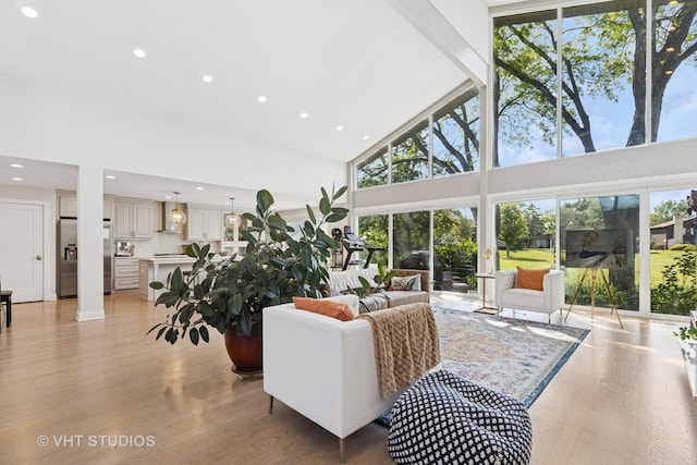 3118 River Falls Dr, Northbrook, IL 60062 - living area featuring high vaulted ceiling, healthy amount of natural light, light wood-style floors, recessed lighting, and beam ceiling