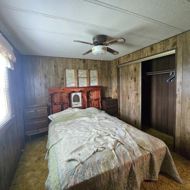 16306 W Canada Rd, Polo, IL 61064 - bedroom with wood walls, carpet floors, a closet, a ceiling fan, and a textured ceiling