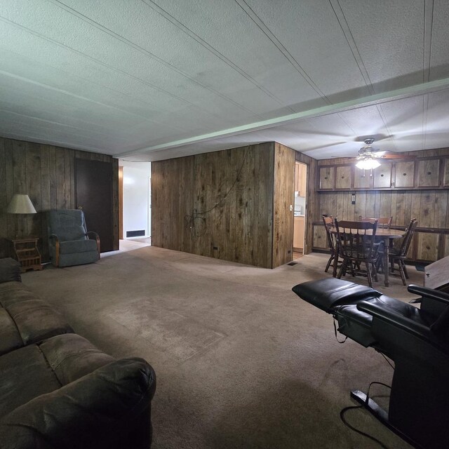 16306 W Canada Rd, Polo, IL 61064 - carpeted living area featuring wooden walls, a ceiling fan, and a textured ceiling