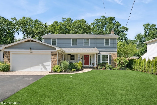 200 W Center Ave, Lake Bluff, IL 60044 - traditional-style house featuring brick siding, a porch, driveway, a front yard, and a chimney