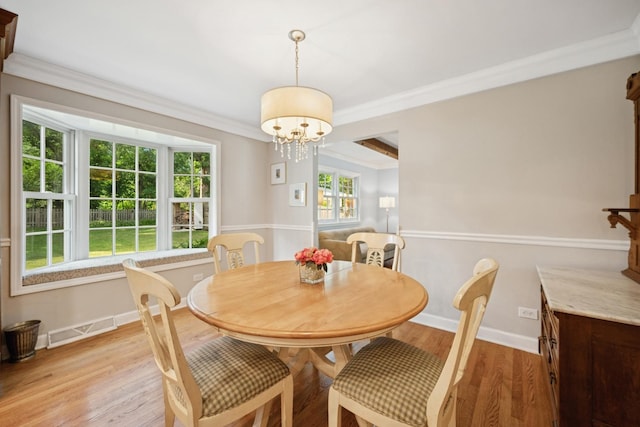 200 W Center Ave, Lake Bluff, IL 60044 - dining space featuring ornamental molding, light wood-style flooring, and a chandelier