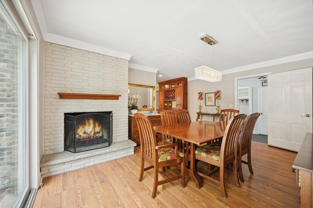 200 W Center Ave, Lake Bluff, IL 60044 - dining area with ornamental molding, wood finished floors, and a brick fireplace