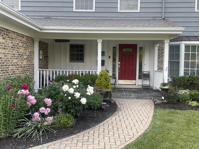 200 W Center Ave, Lake Bluff, IL 60044 - entrance to property with board and batten siding, covered porch, a shingled roof, and brick siding