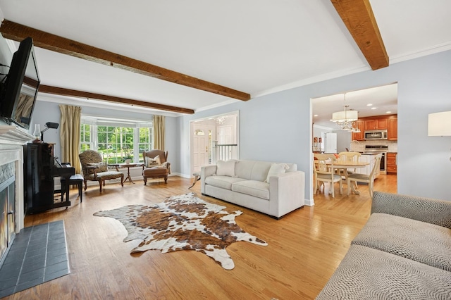 200 W Center Ave, Lake Bluff, IL 60044 - living room featuring beamed ceiling, a fireplace with flush hearth, light wood finished floors, and a chandelier