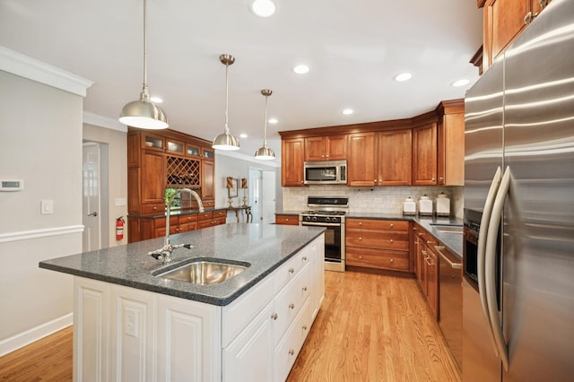 200 W Center Ave, Lake Bluff, IL 60044 - kitchen with appliances with stainless steel finishes, brown cabinets, decorative backsplash, light wood finished floors, and recessed lighting