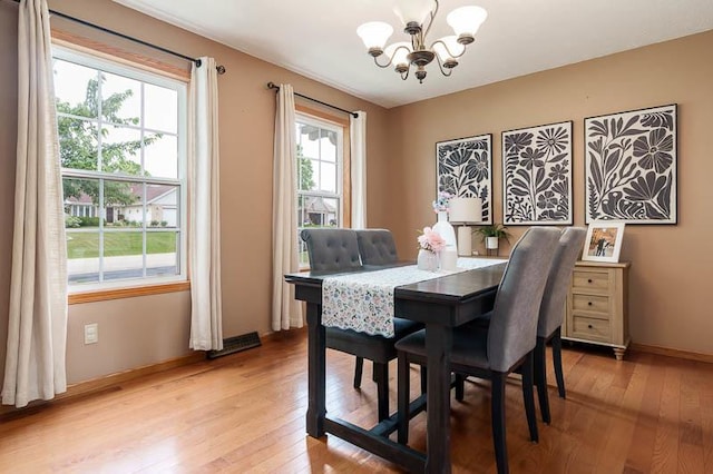10873 Meadowsweet Ln, Roscoe, IL 61073 - dining area with a chandelier and light wood finished floors