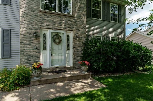 10873 Meadowsweet Ln, Roscoe, IL 61073 - doorway to property featuring a lawn and brick siding