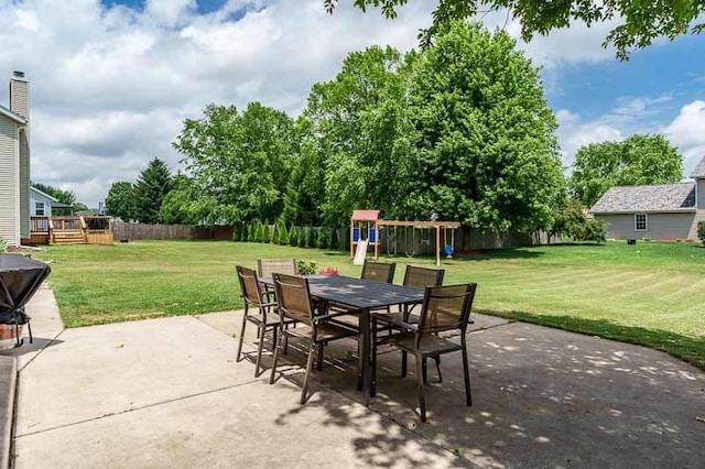 10873 Meadowsweet Ln, Roscoe, IL 61073 - fenced backyard featuring a patio, outdoor dining space, and a playground