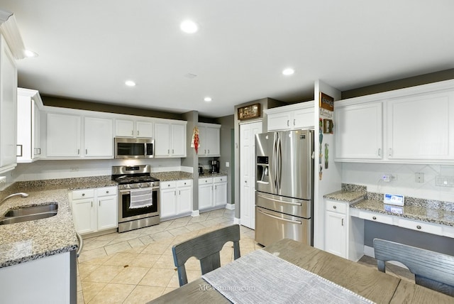 2943 Heather Ln, Montgomery, IL 60538 - kitchen featuring appliances with stainless steel finishes, light tile patterned floors, white cabinets, tasteful backsplash, and recessed lighting