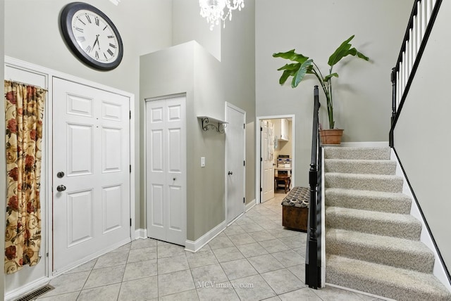 2943 Heather Ln, Montgomery, IL 60538 - foyer with a high ceiling, stairway, light tile patterned flooring, and a chandelier