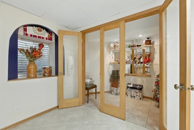 2943 Heather Ln, Montgomery, IL 60538 - corridor featuring a paneled ceiling, french doors, and tile patterned floors