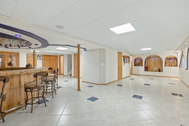 2943 Heather Ln, Montgomery, IL 60538 - interior space with wet bar, a drop ceiling, light tile patterned floors, and stairs