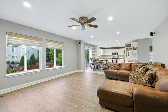 2943 Heather Ln, Montgomery, IL 60538 - living area with ceiling fan, light wood finished floors, and recessed lighting