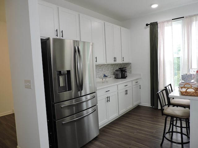 516 Wolverine Dr, Aurora, IL 60502 - kitchen with stainless steel refrigerator with ice dispenser, light countertops, dark wood-style flooring, decorative backsplash, and white cabinets