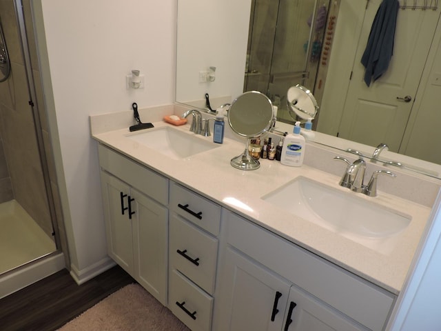516 Wolverine Dr, Aurora, IL 60502 - full bathroom featuring a stall shower, double vanity, and wood finished floors