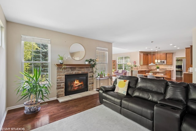 2865 Trail Crest Ln, Lindenhurst, IL 60046 - living area featuring dark wood finished floors, healthy amount of natural light, a stone fireplace, and recessed lighting