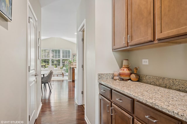 2865 Trail Crest Ln, Lindenhurst, IL 60046 - kitchen with dark wood-style floors, vaulted ceiling, and light stone counters