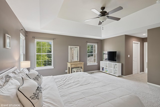 2865 Trail Crest Ln, Lindenhurst, IL 60046 - bedroom featuring a raised ceiling, multiple windows, carpet, and a ceiling fan