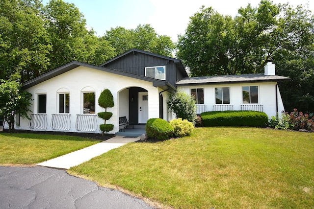 21025 Cambridge Ln, Olympia Fields, IL 60461 - tri-level home with a porch, a front lawn, a chimney, and brick siding
