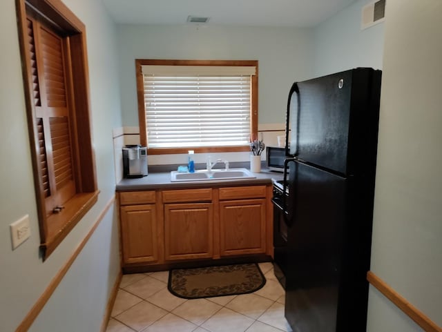 19 Cour Saint Tropez Ct Unit 19, Palos Hills, IL 60465 - kitchen with freestanding refrigerator, light tile patterned flooring, brown cabinets, and stainless steel microwave
