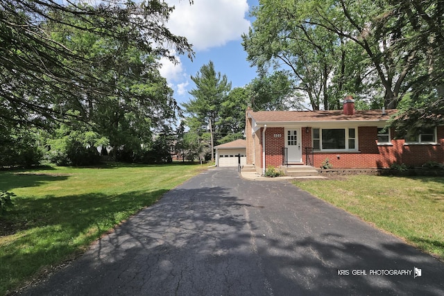 5505 Oak Park Rd, Cary, IL 60013 - view of front of home featuring brick siding, a chimney, a front lawn, and a garage