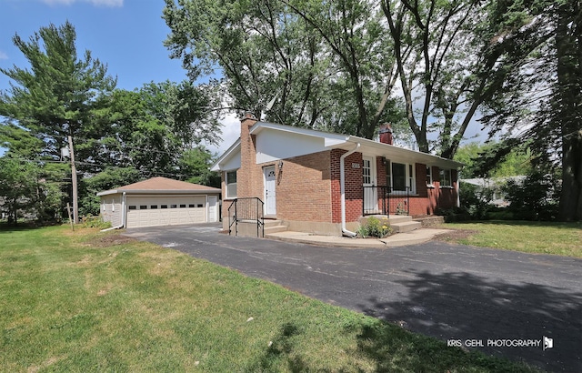 5505 Oak Park Rd, Cary, IL 60013 - view of front facade with a chimney, brick siding, an outbuilding, and a garage