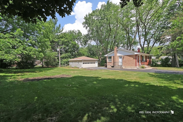 5505 Oak Park Rd, Cary, IL 60013 - view of grassy yard featuring a garage, an outdoor structure, and view of scattered trees