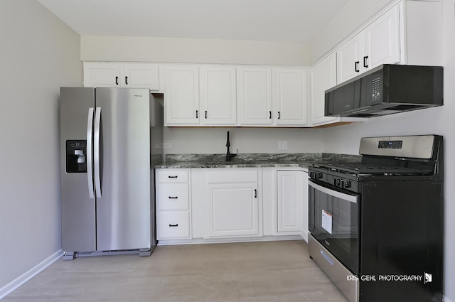 5505 Oak Park Rd, Cary, IL 60013 - kitchen with appliances with stainless steel finishes, light wood-type flooring, dark stone countertops, and white cabinetry